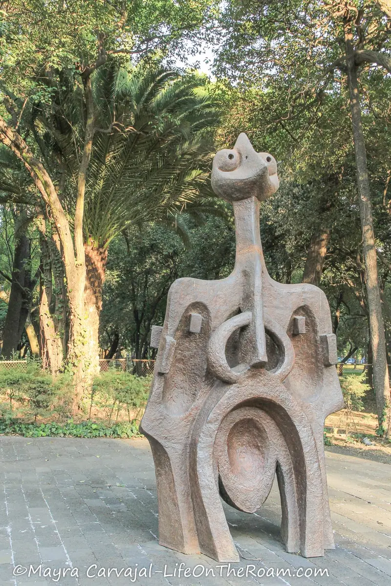 A sculpture resembling a bird, in a park