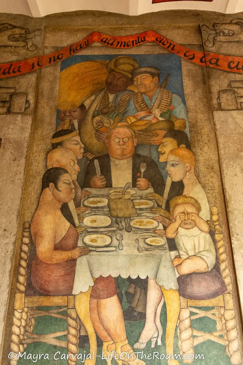 A fresco depicting rich people at dinner with little to eat