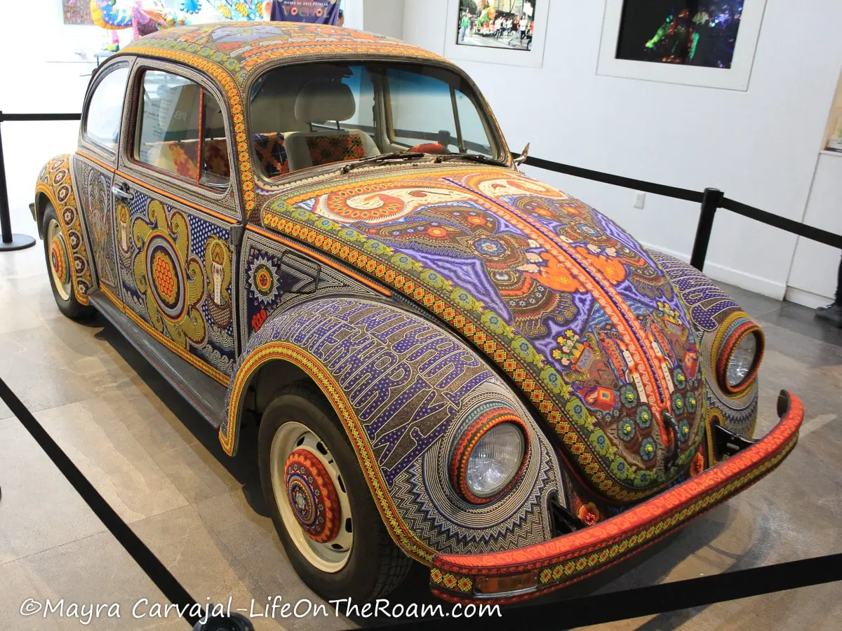 A Volkswagen beetle covered in multicolour beads