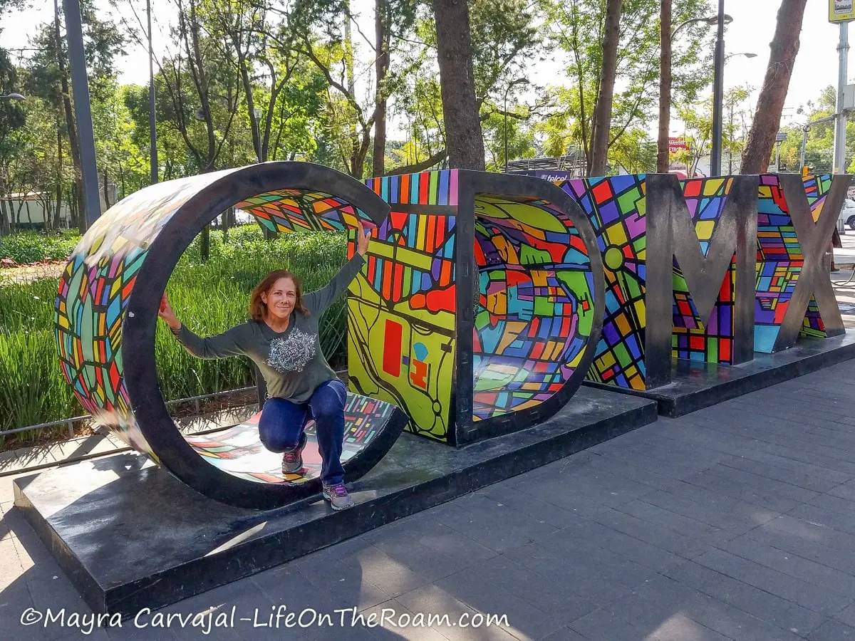Mayra posing inside a sign with the letters CDMX
