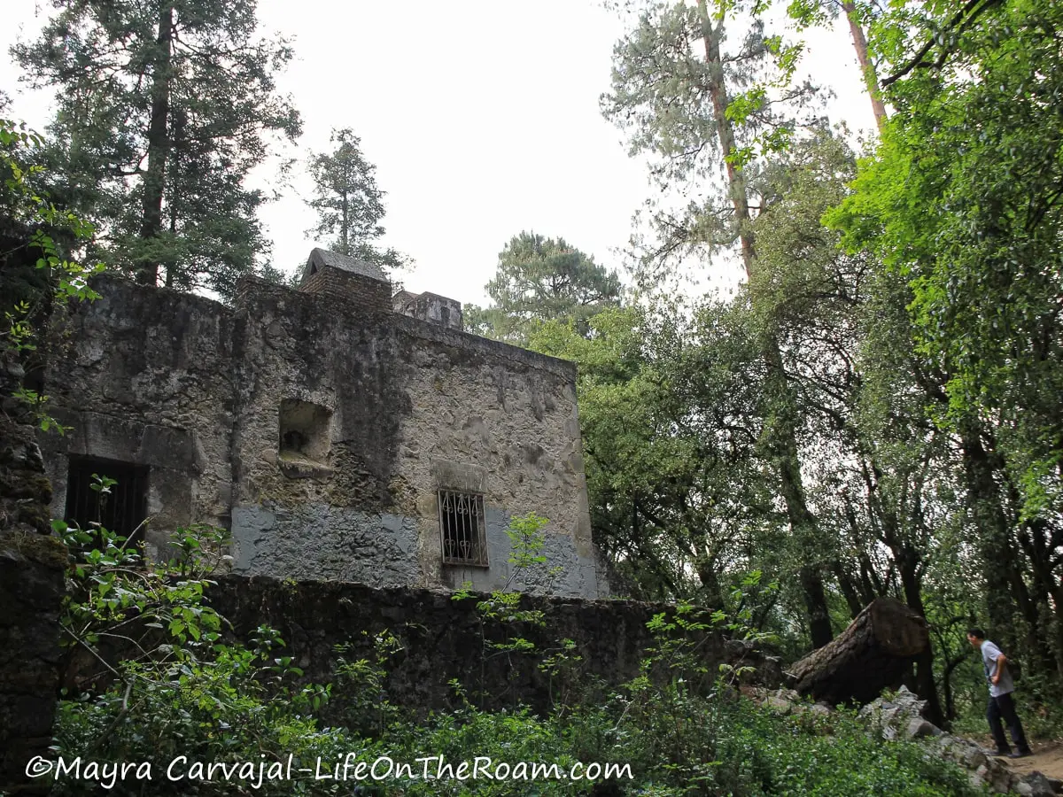 An old hermitage with stone walls in a cloudy forest