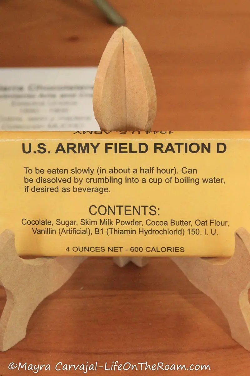 A chocolate bar wrapped in plain yellow paper with the main line reading "U.S. ARMY FIELD RATION D"