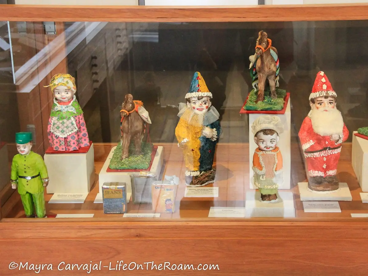 A display case with colourful chocolate figurines like dolls and clowns