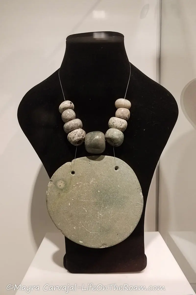 Pectoral with a big flat disc and jade stones