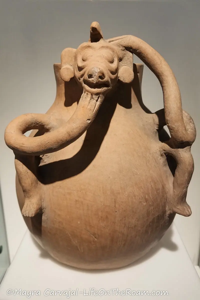 An ancient round vase in clay with zoomorphic shape