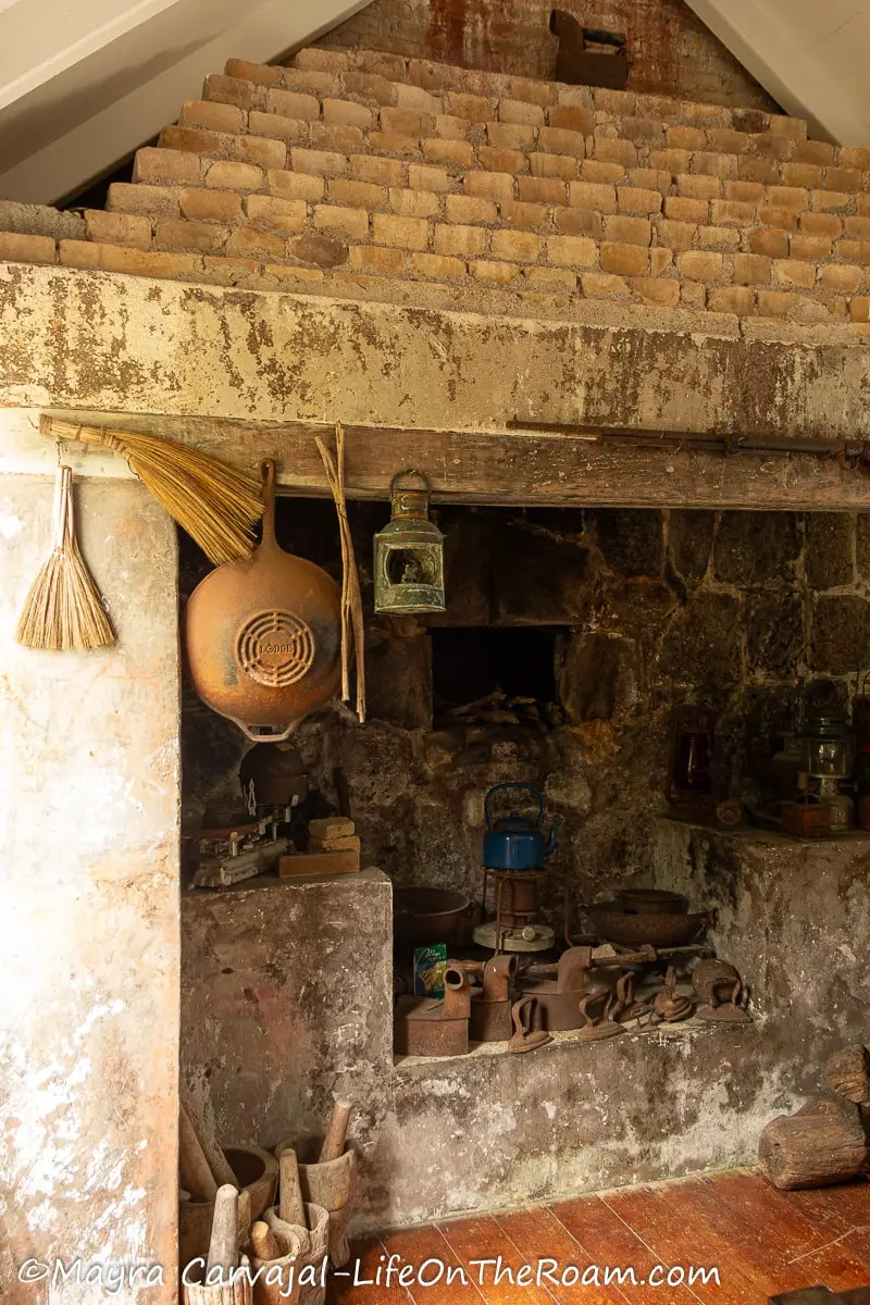 A stone hearth with old utensils in the kitchen of a typical 19th century Saban cottage
