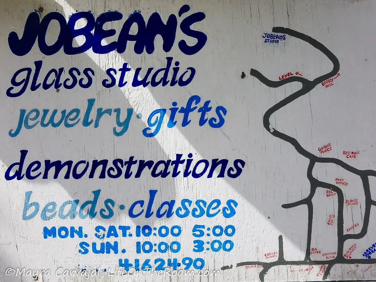 A sign with information about jewelry gifts and demonstrations at Jobean's glass studio on Saba