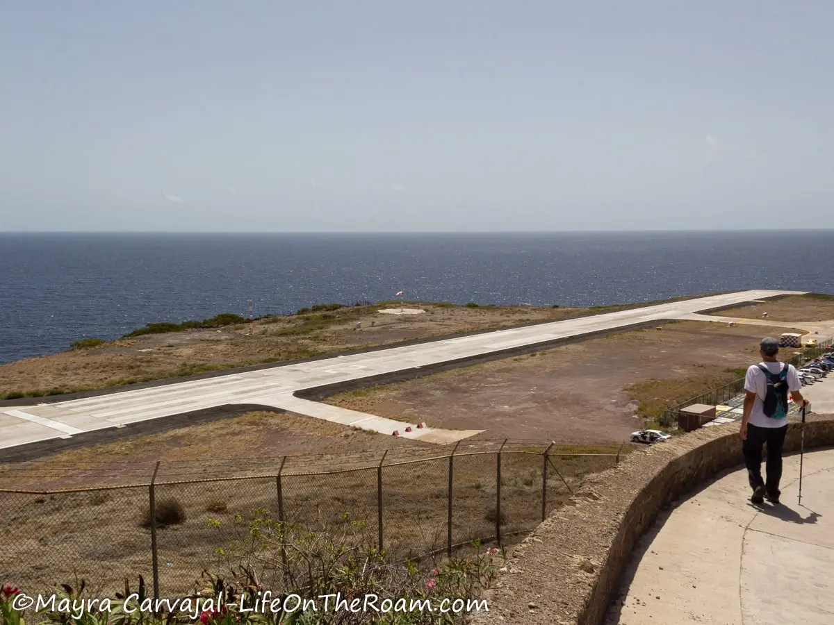 A short airport runway next to the ocean
