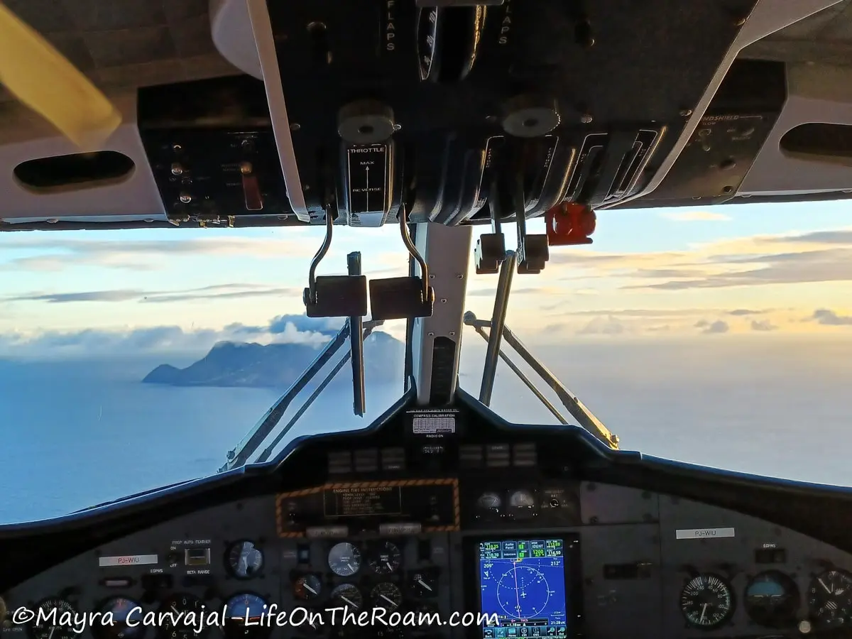 View of the conical shape of the island of Saba through the cockpit of a plane