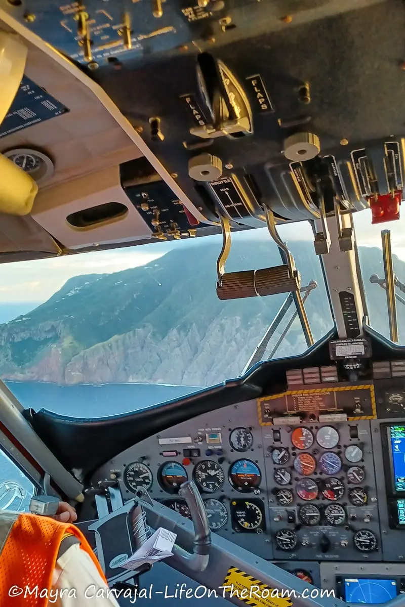 A closer view of the cliffs of Saba island from the open cockpit of a plane