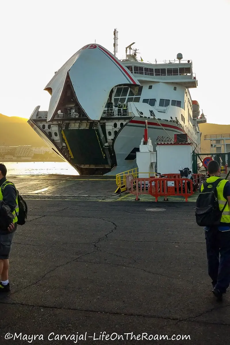 A big ferry with the gate open, approaching the dock