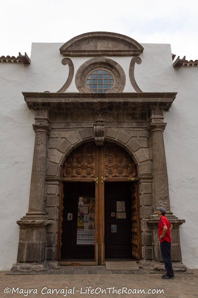 A church from the 16th century with a stone facade and wood doors