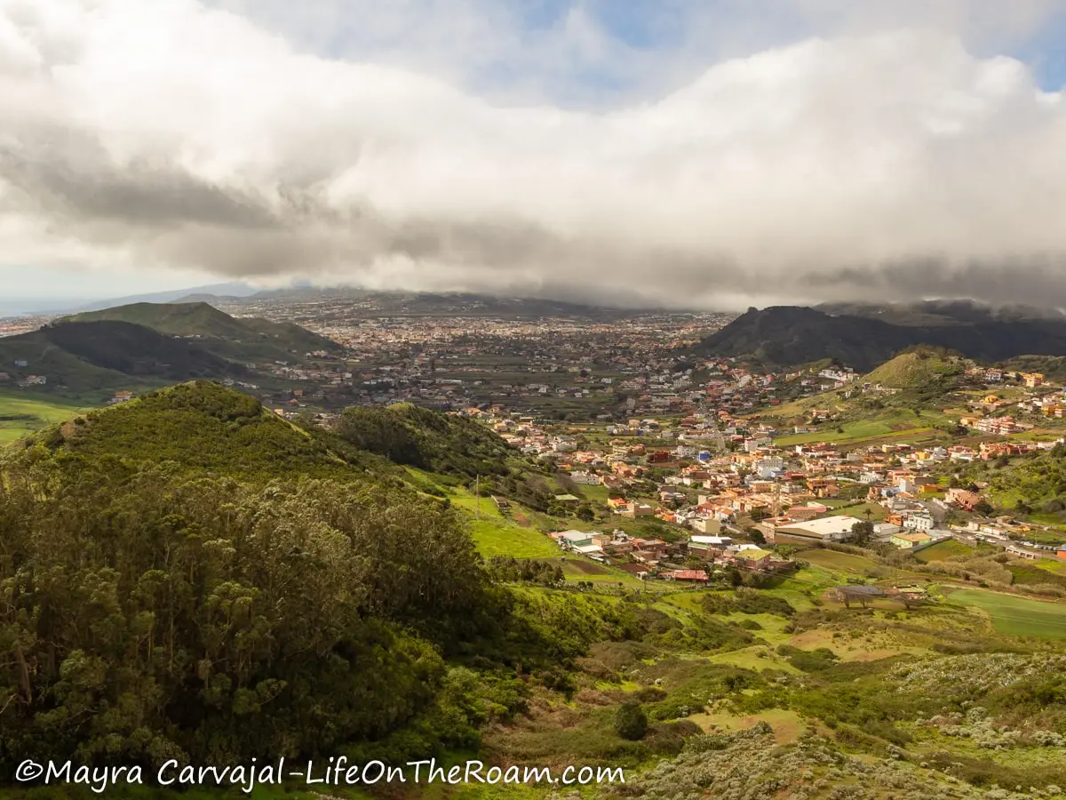 View of a town on the hills of a mountain with green vegetation