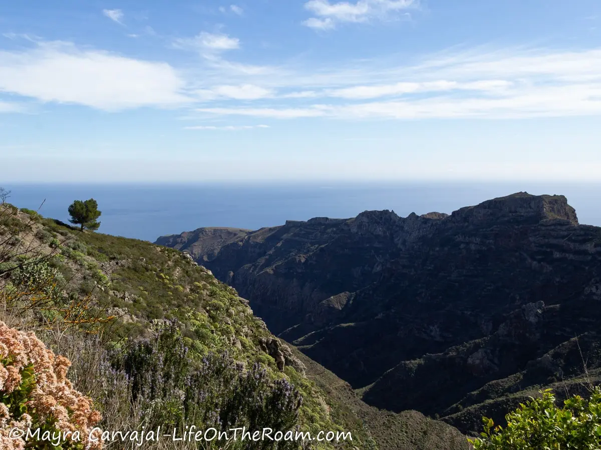 View of the sea beyond mountains and ravines