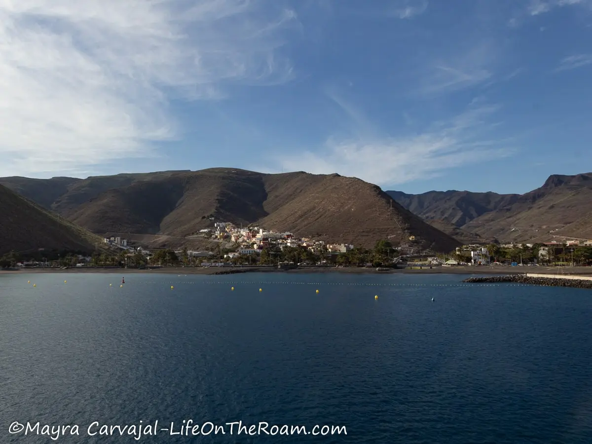 View of mountains with many ridges and buildings along the water's edge