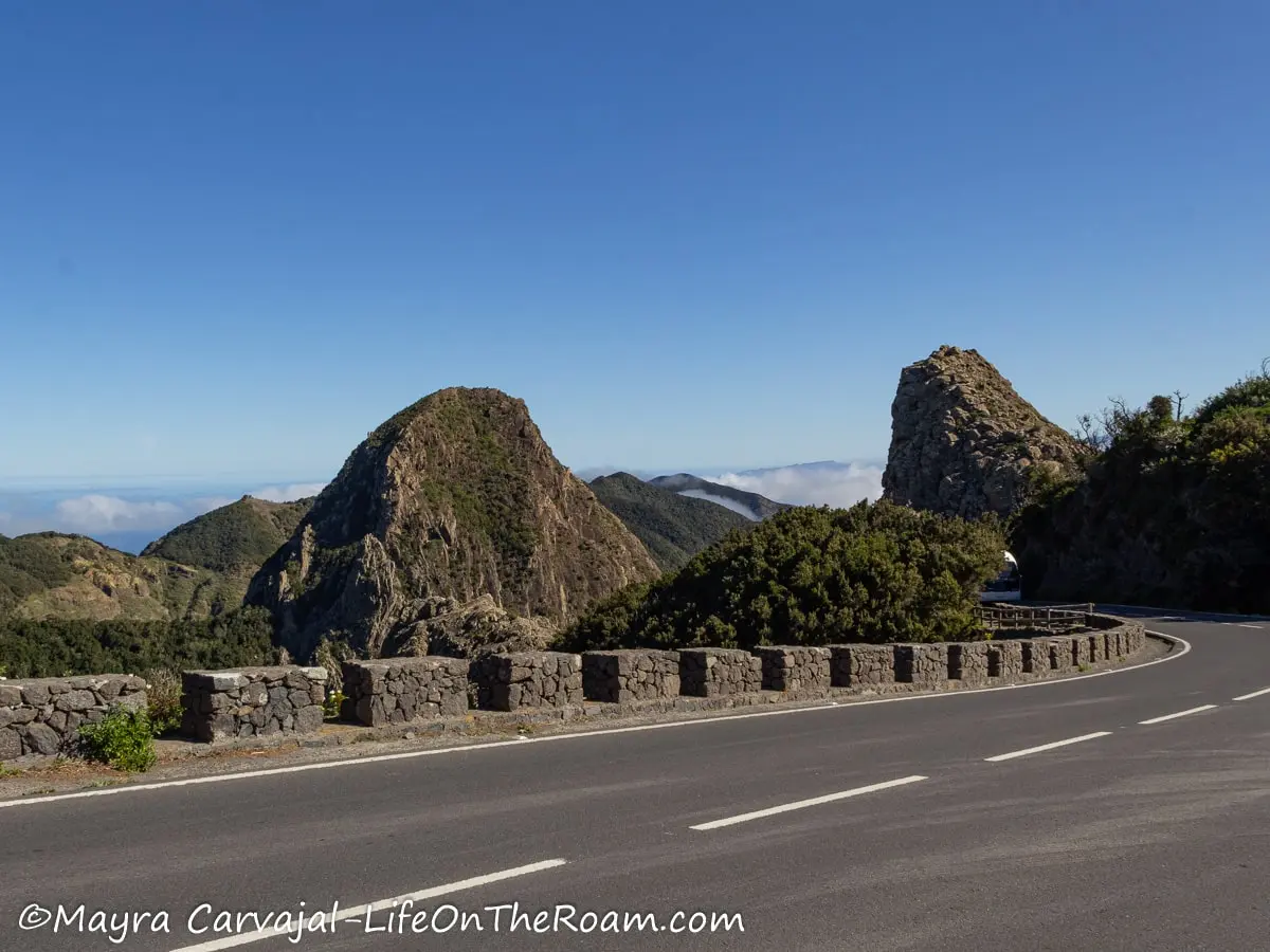 Huge rock formations sticking out of a mountain, on the other side of the road