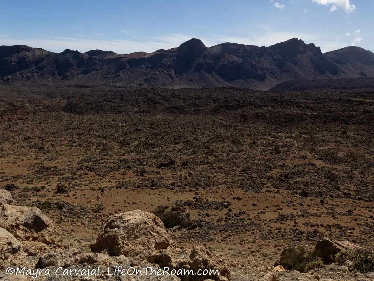 A rocky valley surrounded by jagged mountains in a desert environment