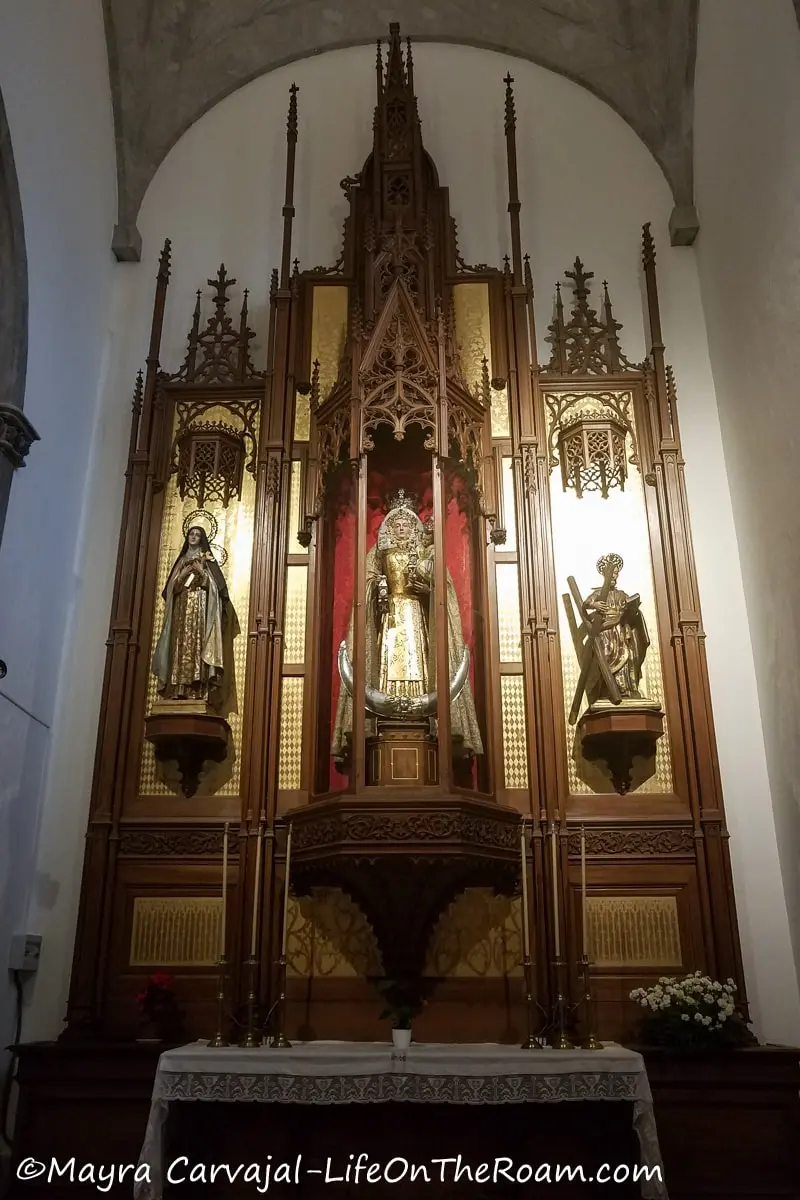 An altar covered in gold with religious statues