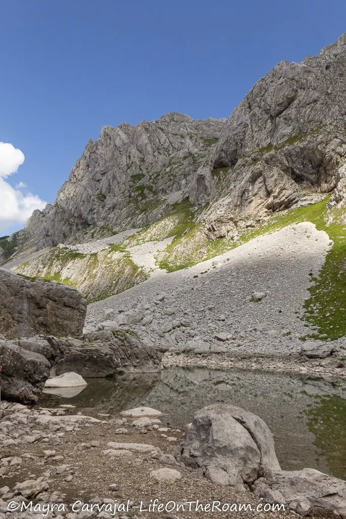 A pond in a mountain valley in a rocky environment