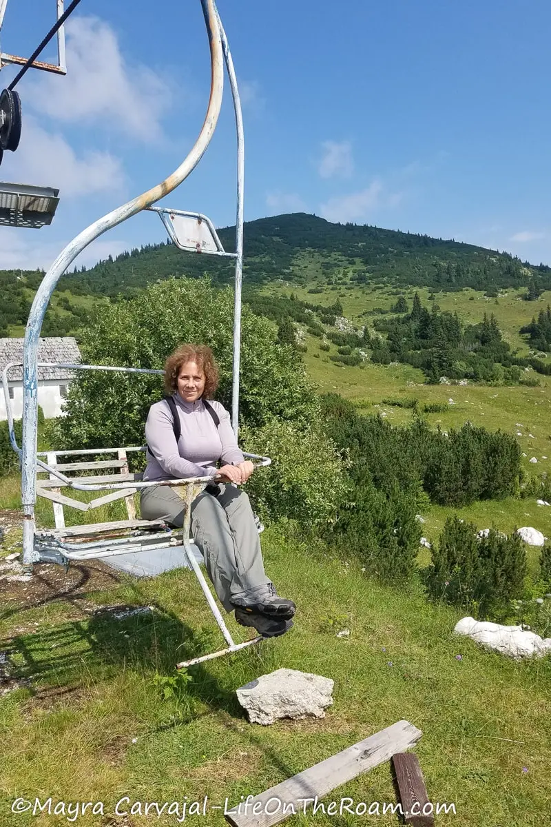 Mayra on an abandoned ski lift in the mountains 