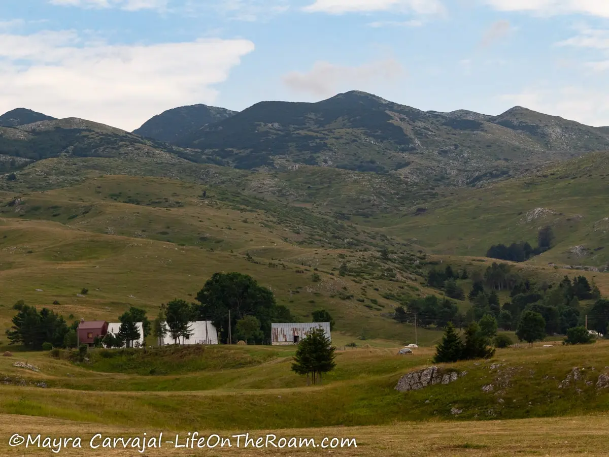 A few chalet-style houses   at the foot of the mountains in the summer