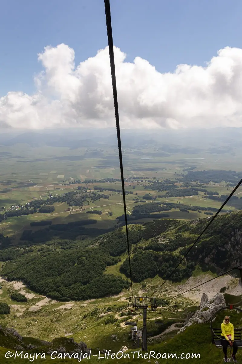 View of a green valley from high up in a ski lift