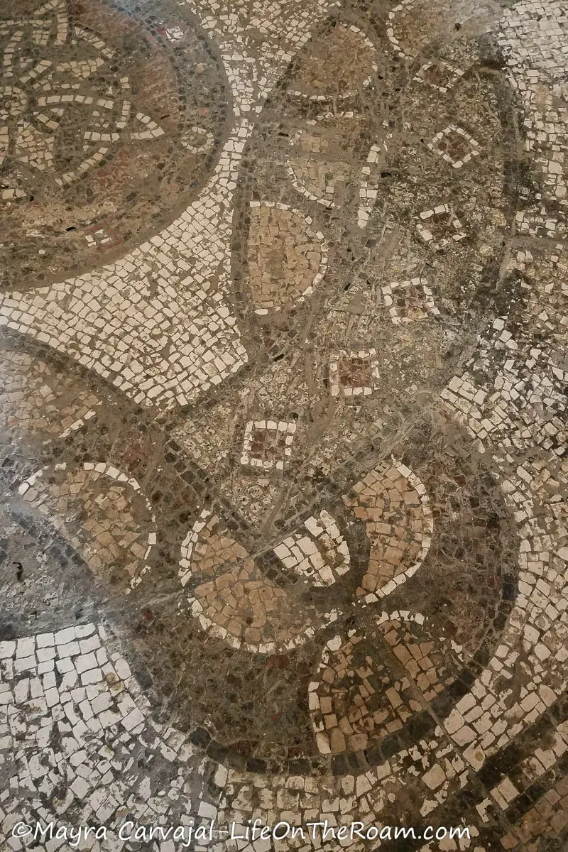 Section of a floor mosaic in beige and earth tones