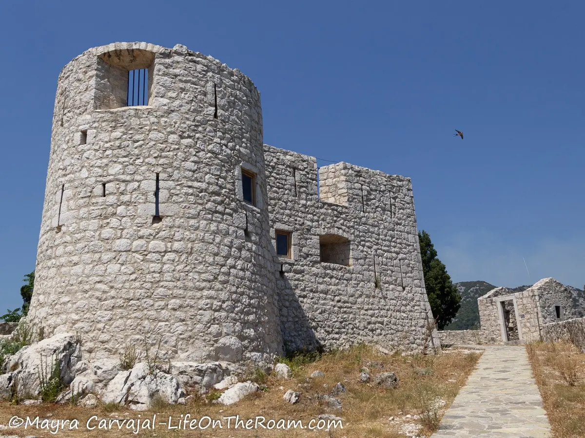 A military construction with a round tower, in cut stone