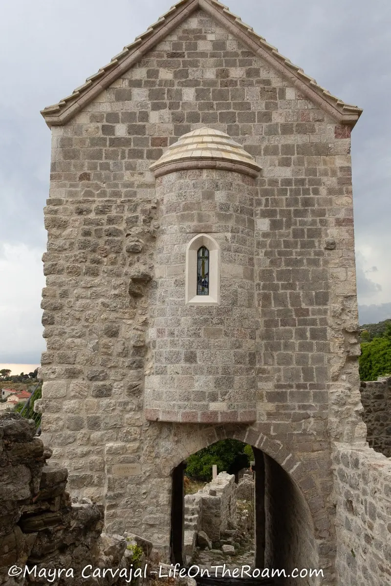 An old church built with cut stone with a turret