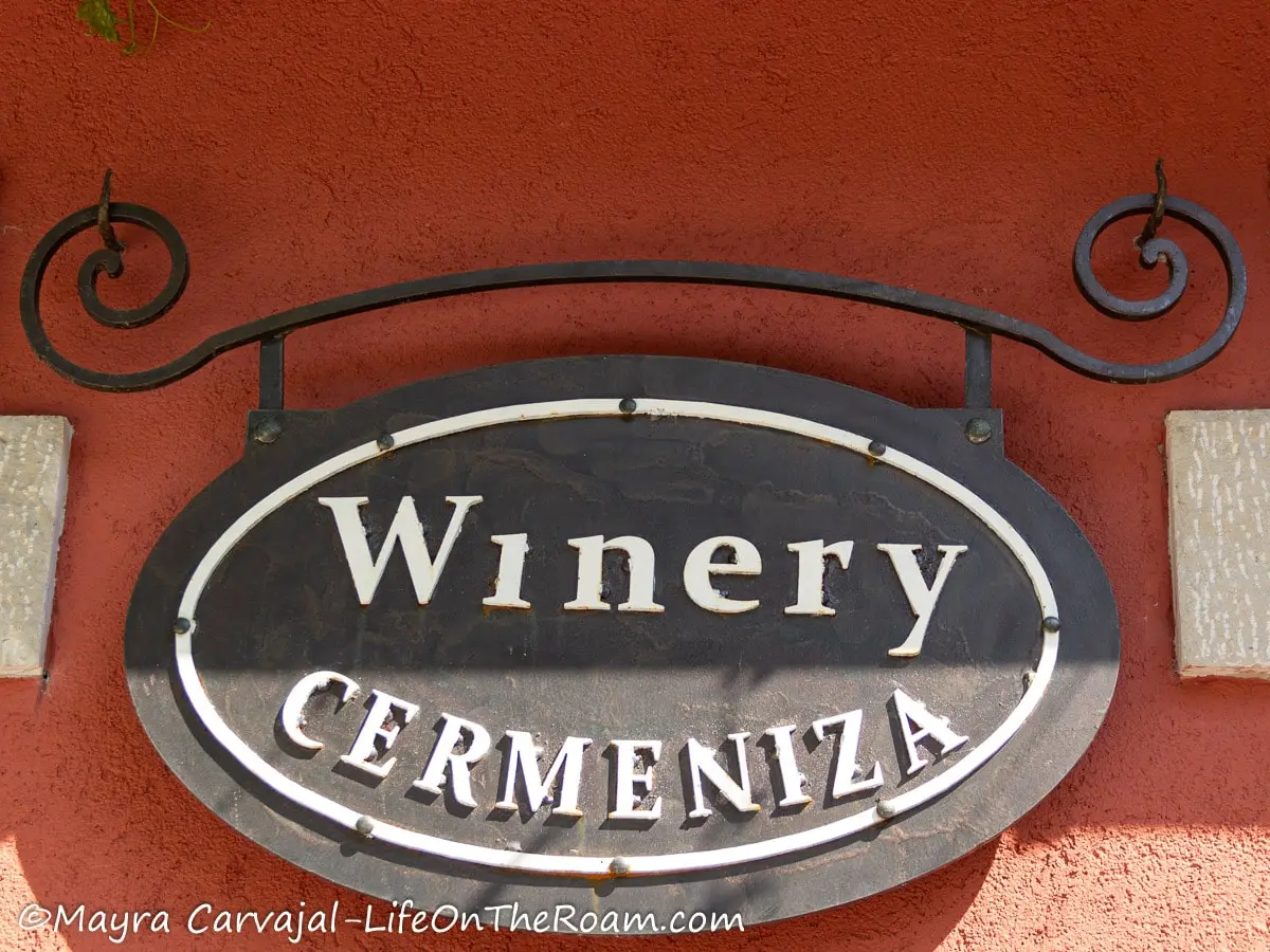 An oval wall sign in metal with the words "Winery Cermeniza"