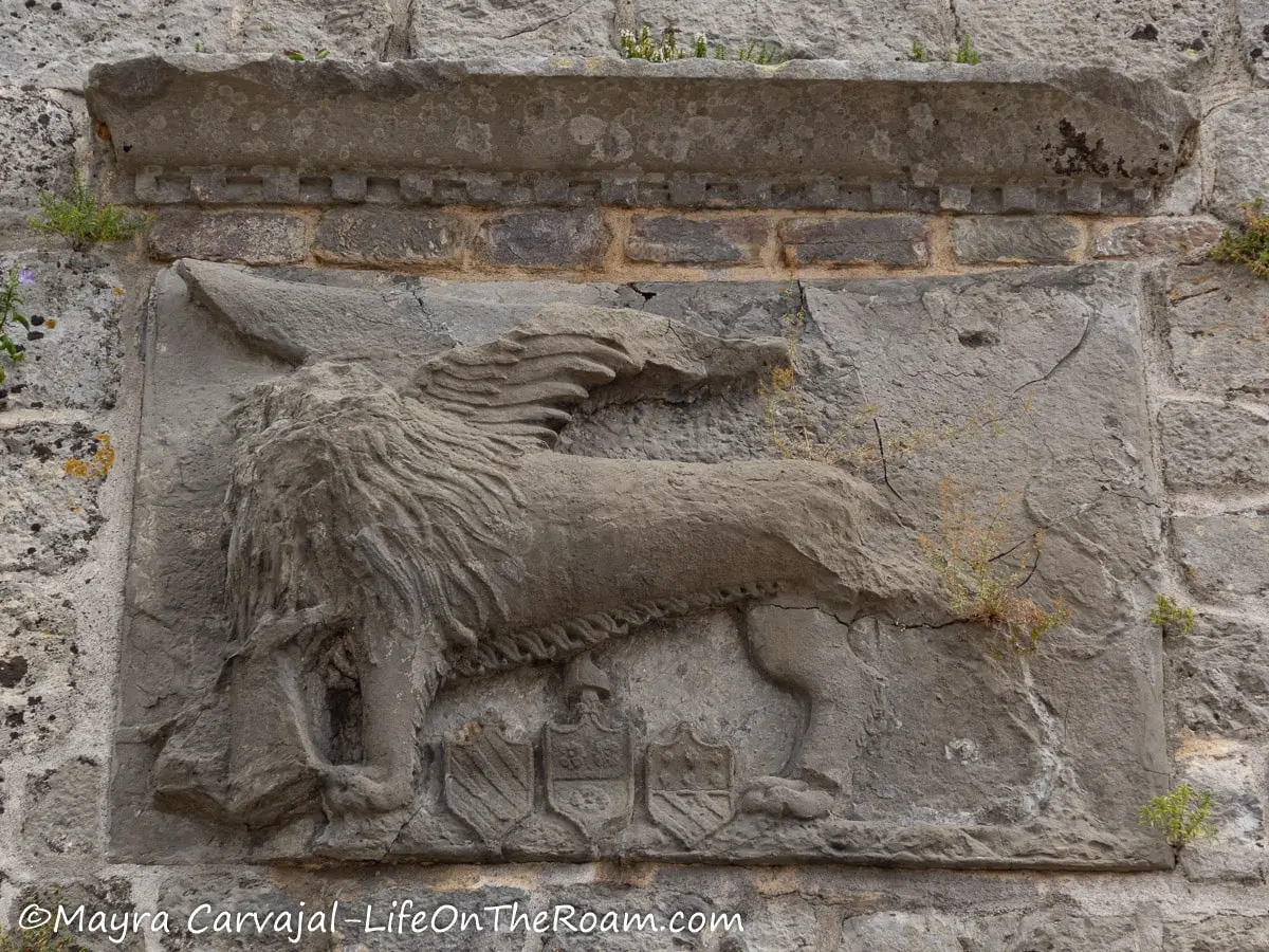 An old plaque in stone depicting a winged lion