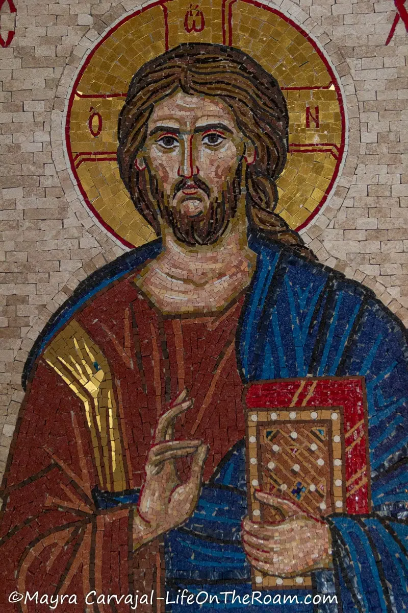 A colour mosaic depicting Jesus teaching, with a robe