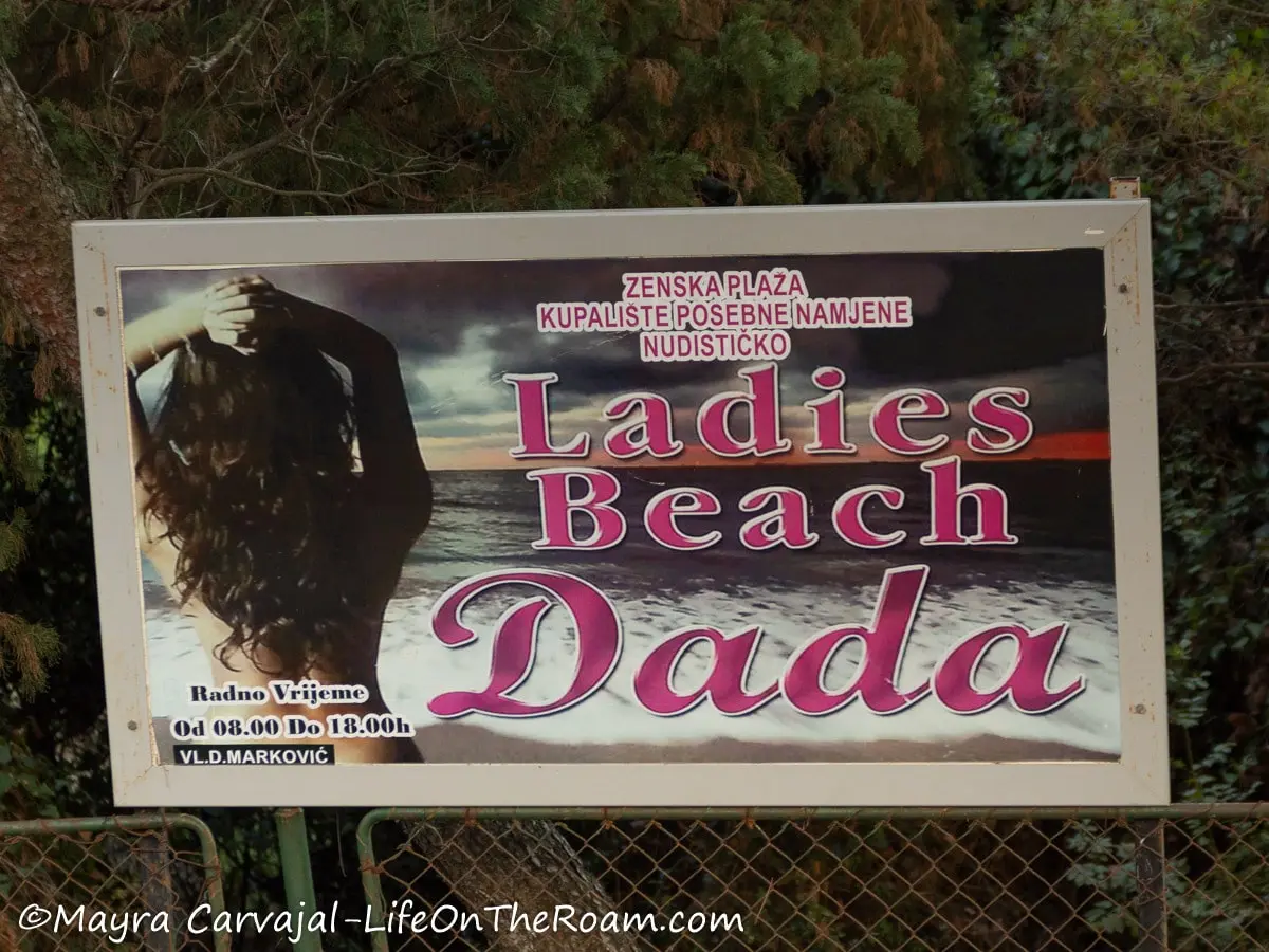 A sign saying "Ladies Beach Dada" with a picture of a woman's back covered by her long hair