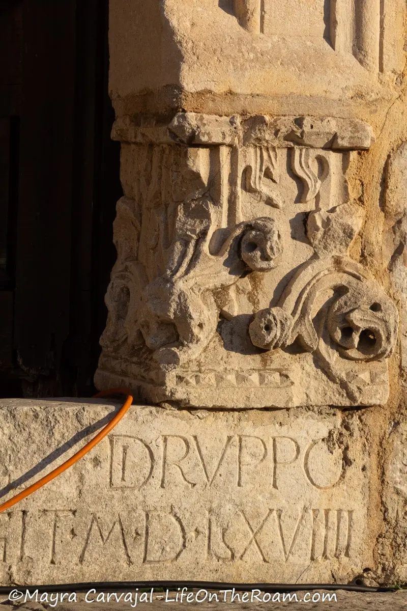 Carving on stone decorating the door frame lower section