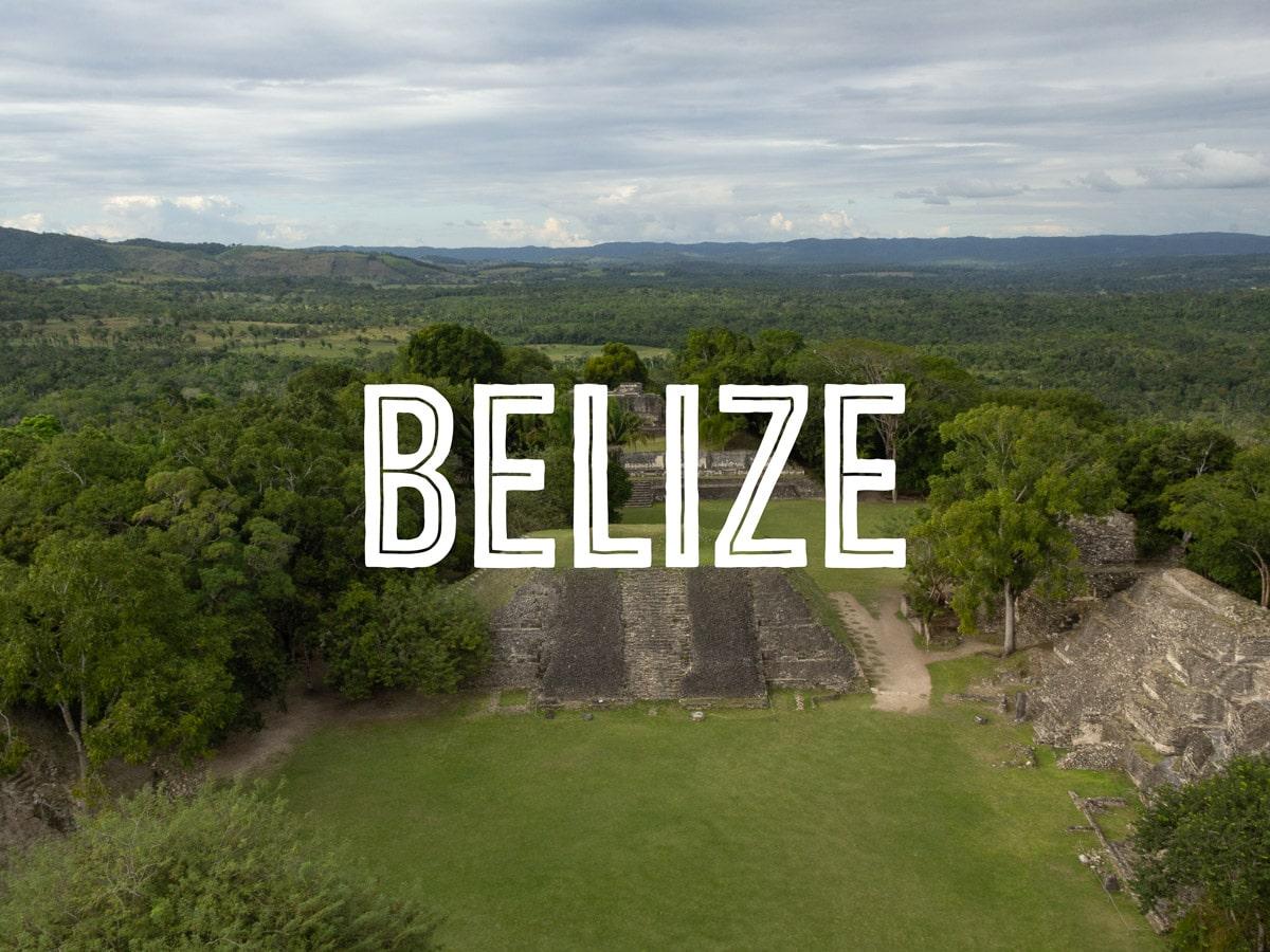 High view of several Mayan pyramids in the jungle,, with the word BELIZE