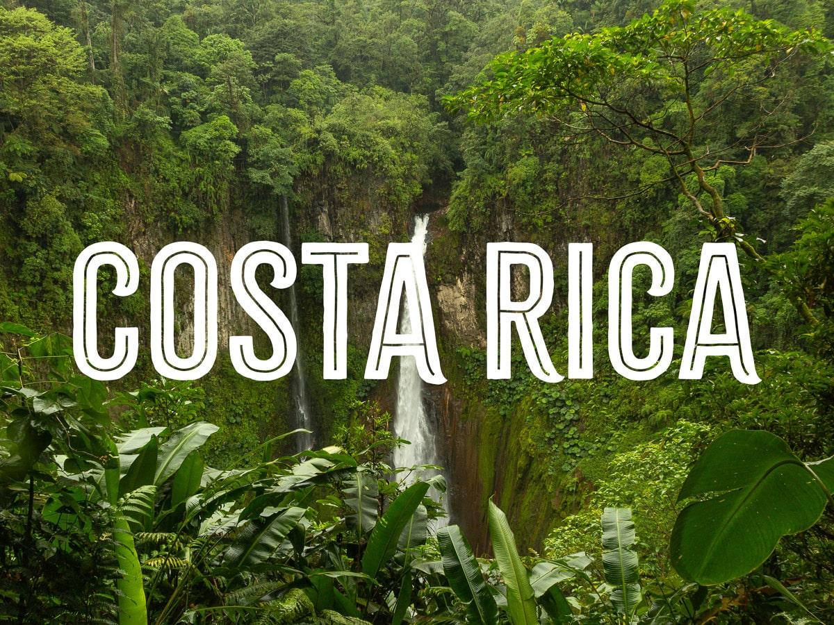 A tall waterfall in the thick jungle with the word COSTA RICA