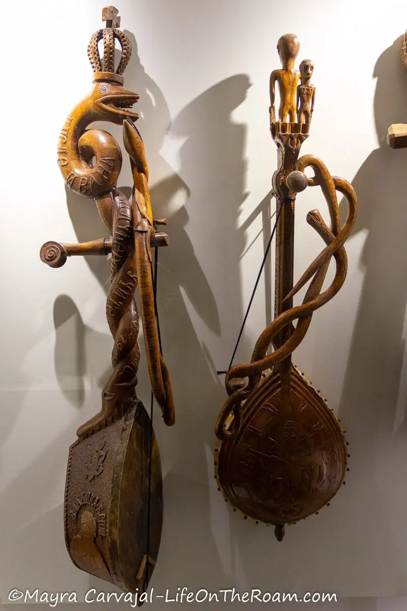 Two traditional musical instruments resembling a small guitar, with folk style adornments