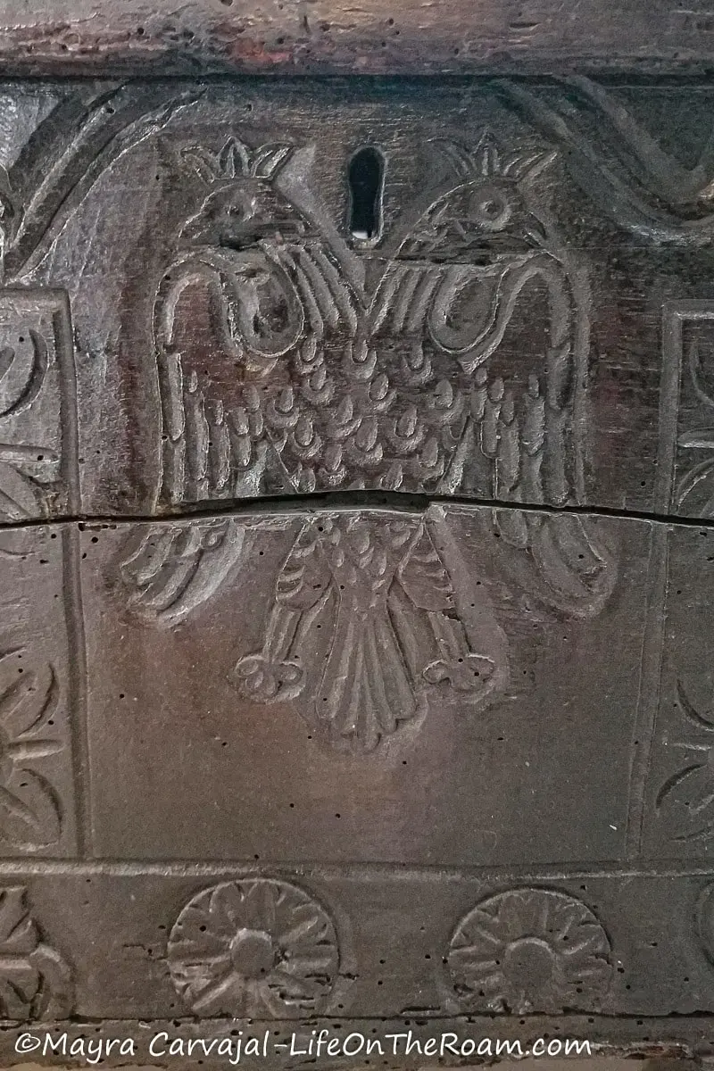 A double headed eagle carved on a piece of dark wood