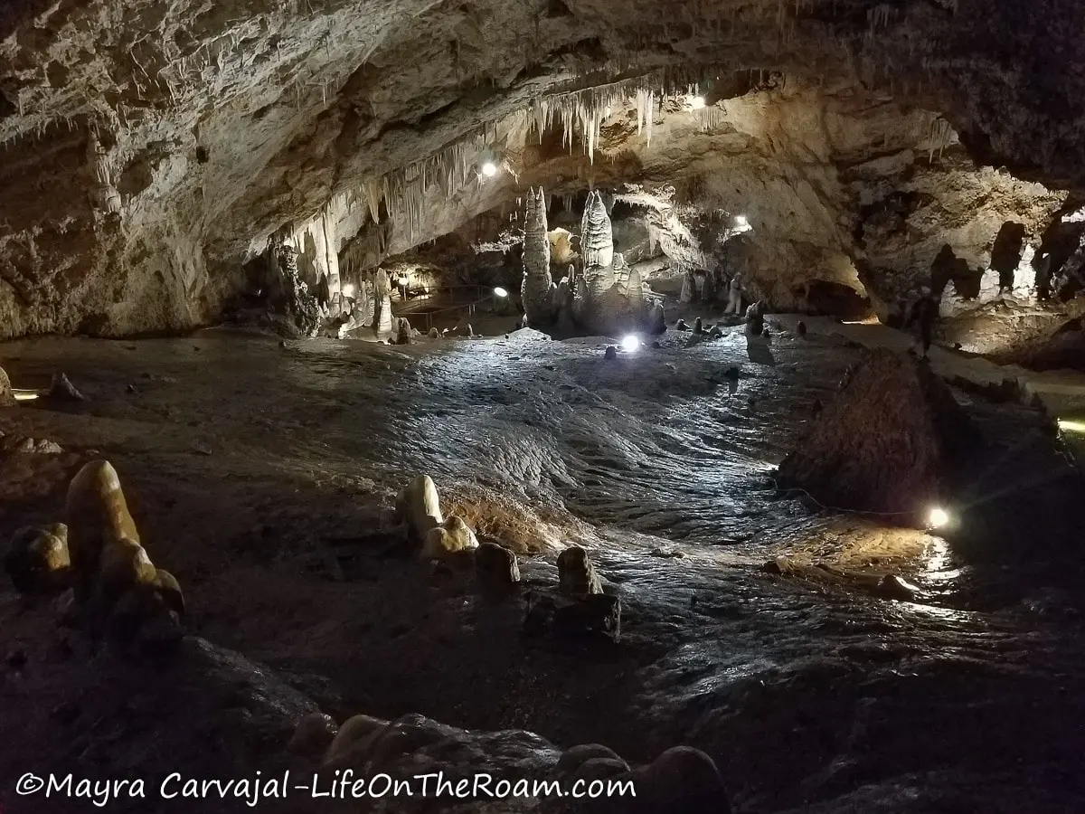 A cave with a swirling floor and several cave formations