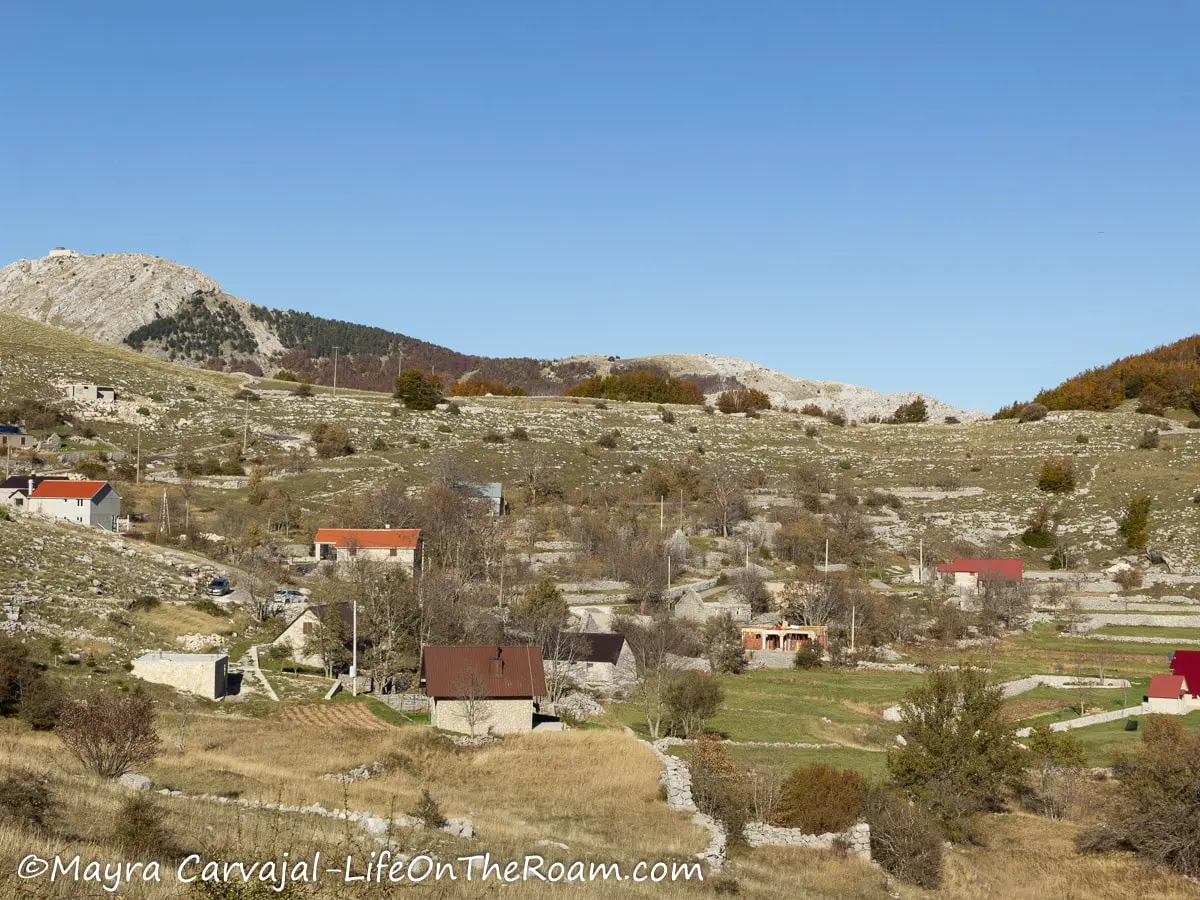 A small village in a valley, with traditional houses