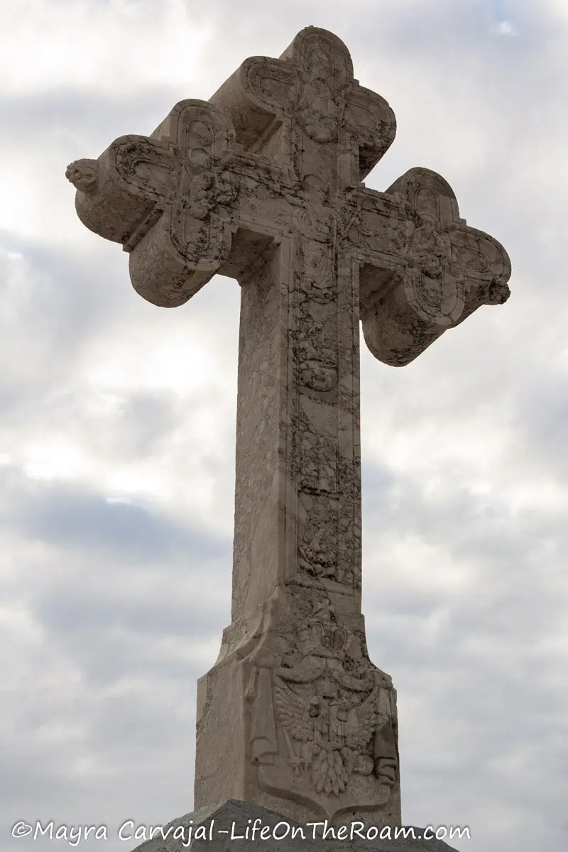 A cross in marble carved with decorative details