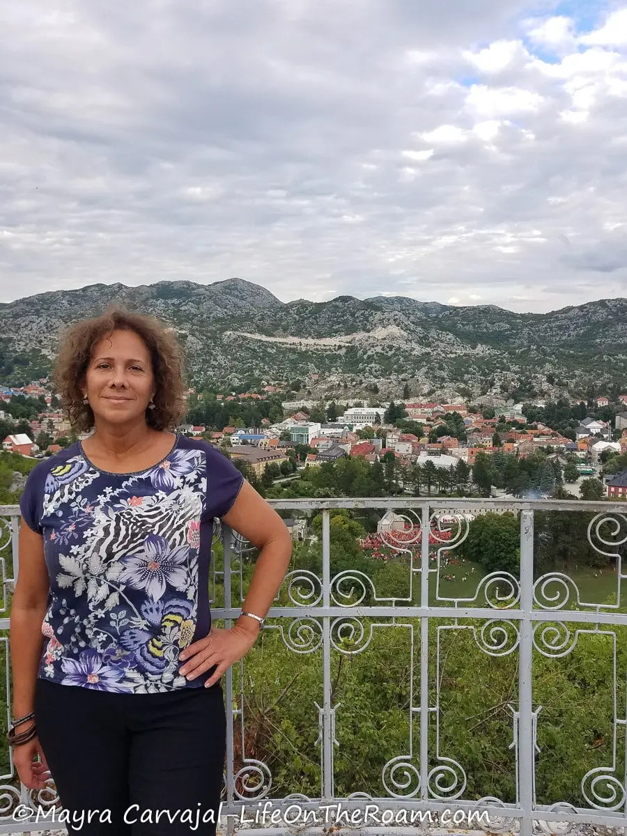 Mayra standing at a lookout overlooking Cetinje and the mountains