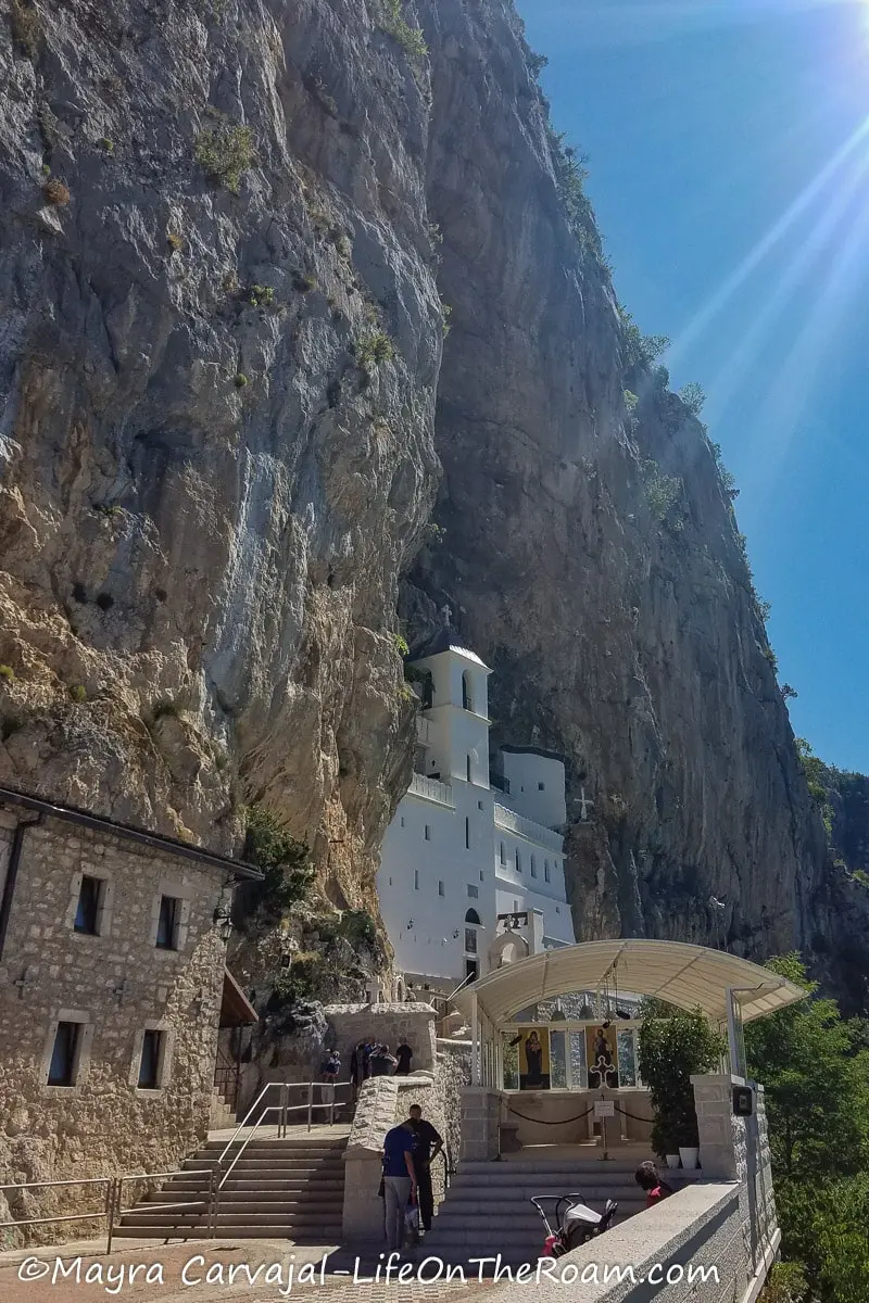 Sunshine rays over a white building built on a cliff