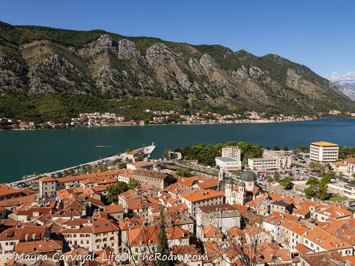 View of a ridge across the water and a historic town right below