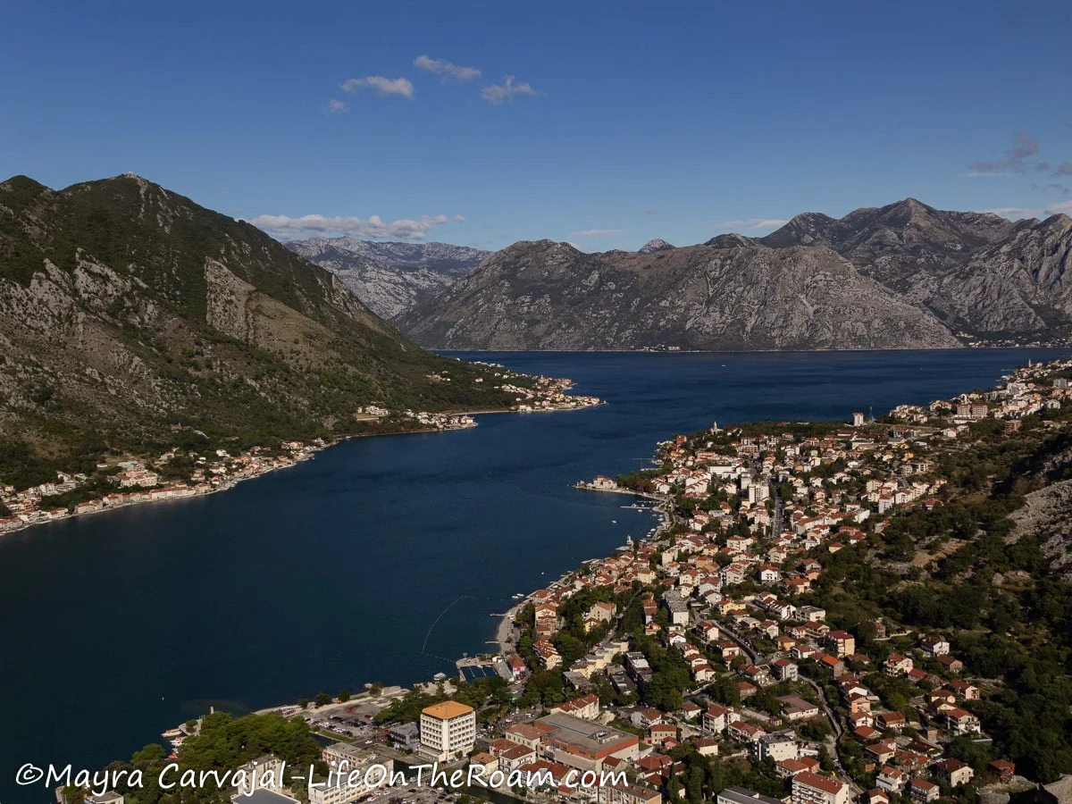 High view of several ridges, a bay, and small towns along the shore