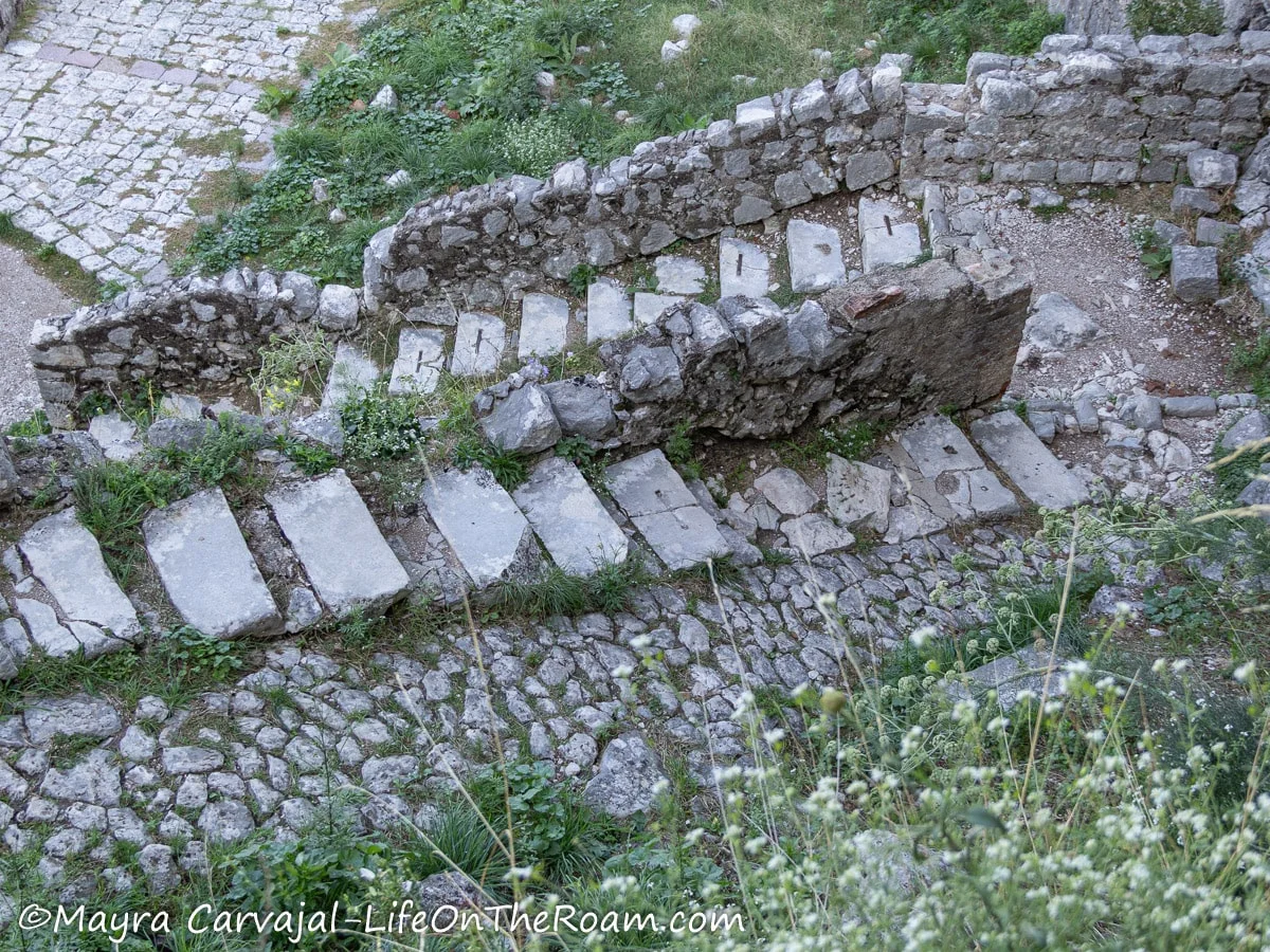 Narrow old stone steps with a stone ramp beside