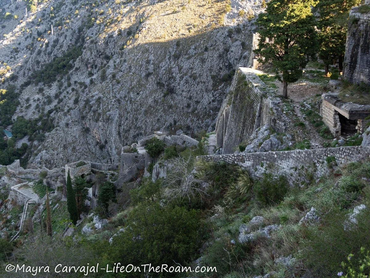 High view of an old defensive wall with posts along a mountain