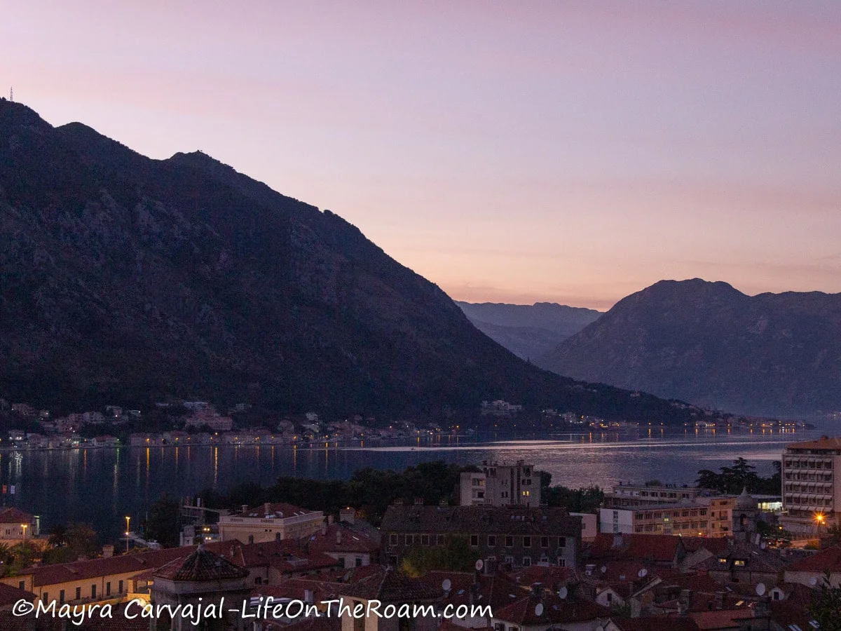 Sunset over the mountains on a bay with coastal towns