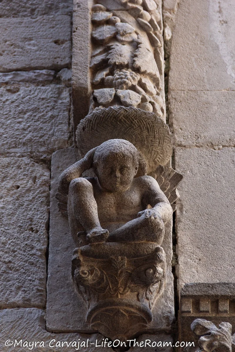 What looks like a stone cherubim in a seated position
