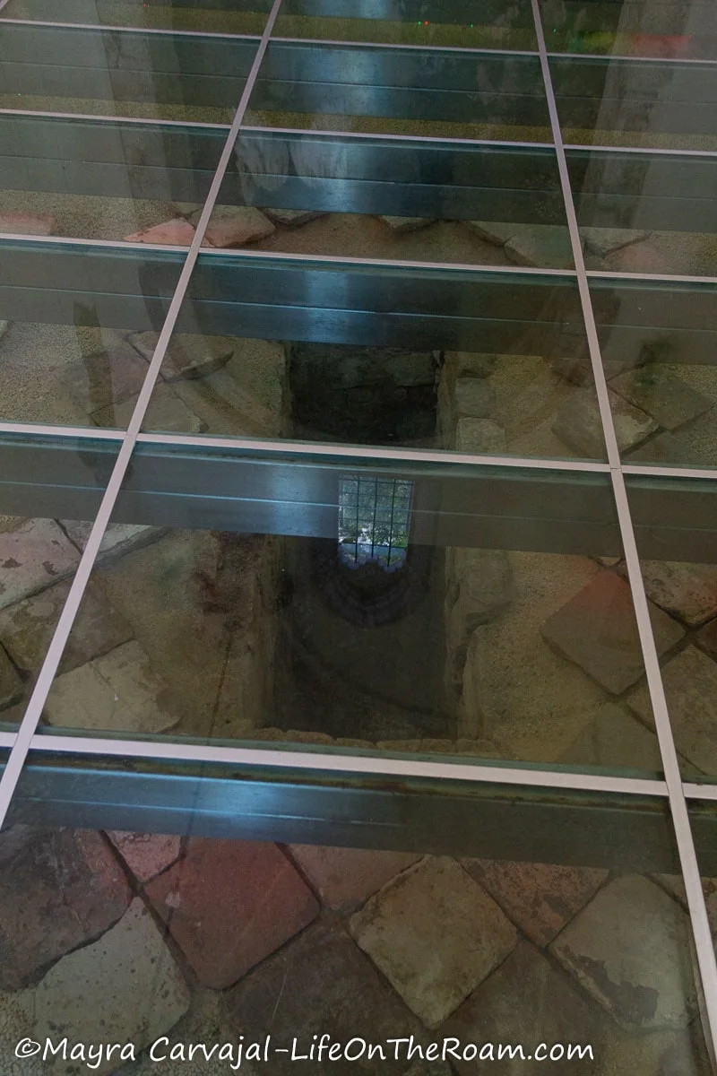 A glass floor showing the original tiled floor underneath